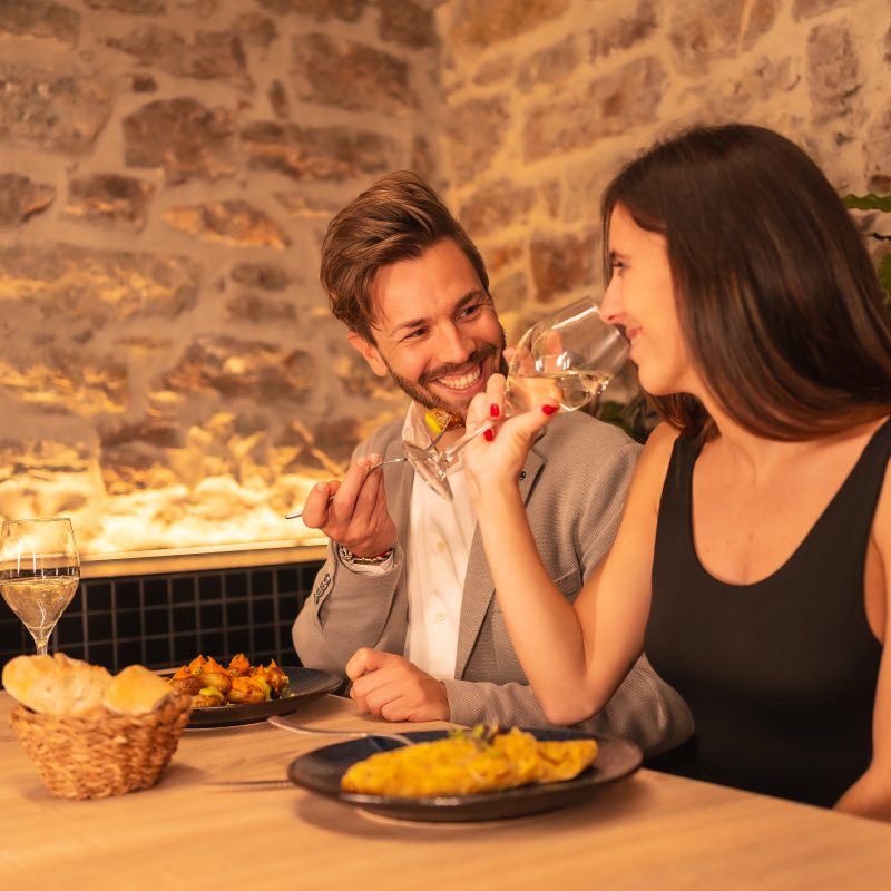 love in a restaurant, toasting glasses of wine, celebrating Valentine's Day